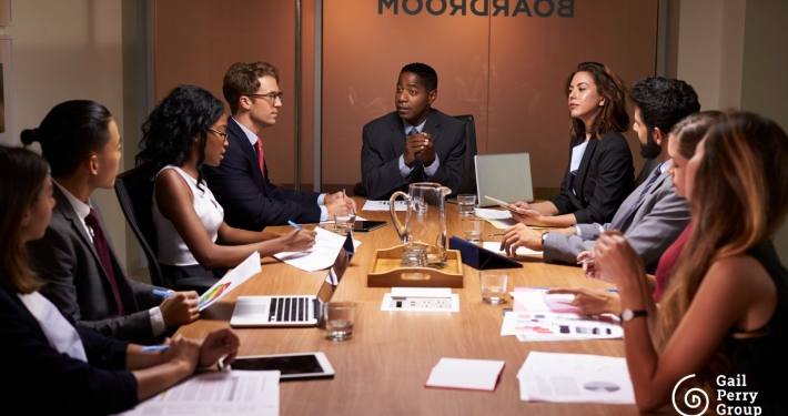 Diverse group of men and women sitting in a boardroom