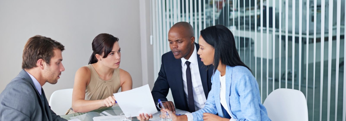 Nonprofit board members in a meeting making urgent decisions