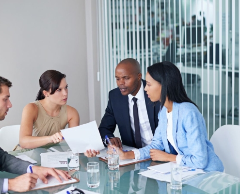 Nonprofit board members in a meeting making urgent decisions