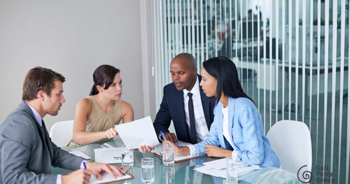 Nonprofit board members in a meeting making urgent decisions