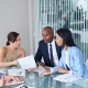 Nonprofit board members in a meeting making urgent decisions