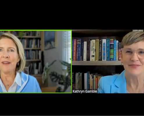 Two women discussing major gift officer skills sitting in front of bookcases.