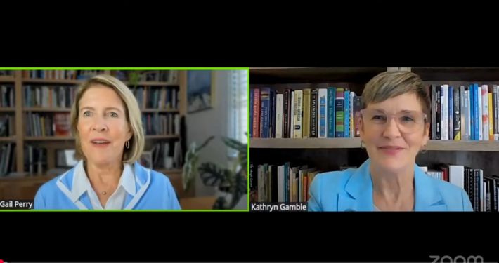 Two women discussing major gift officer skills sitting in front of bookcases.