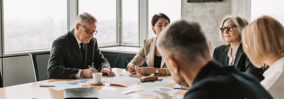 A diverse group of nonprofit professionals gathered around a table, engaged in genuine conversation