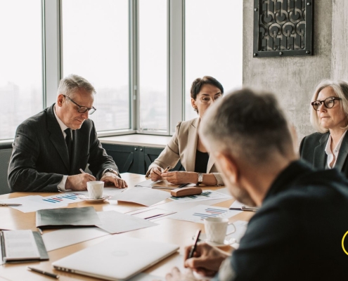 A diverse group of nonprofit professionals gathered around a table, engaged in genuine conversation