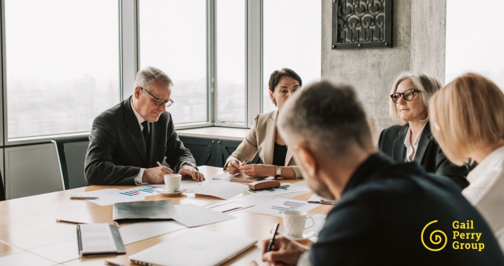 A diverse group of nonprofit professionals gathered around a table, engaged in genuine conversation