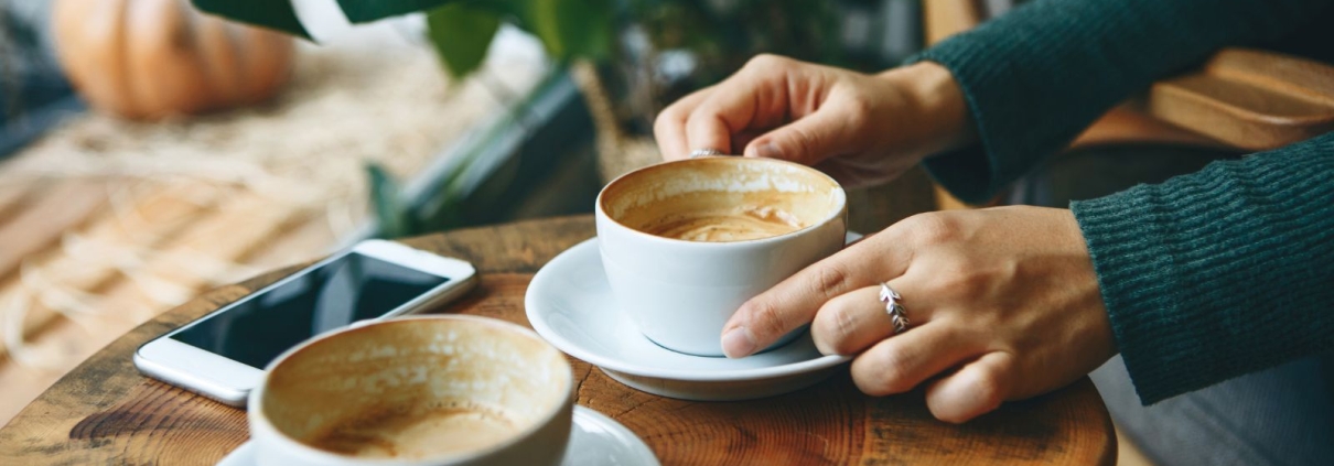 Two people meeting over coffee discussing nonprofit donor relationship and giving
