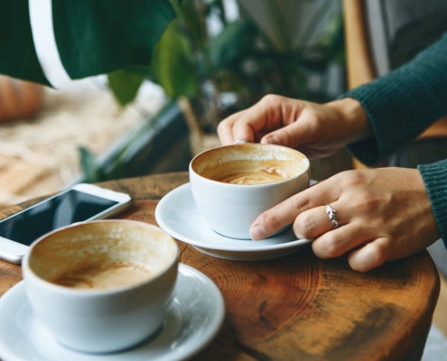 Two people meeting over coffee discussing nonprofit donor relationship and giving