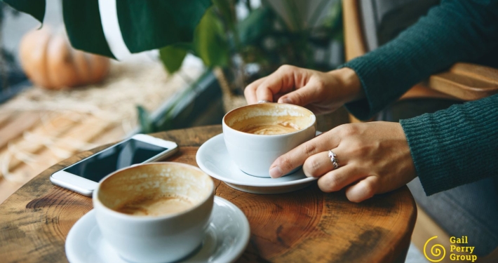 Two people meeting over coffee discussing nonprofit donor relationship and giving
