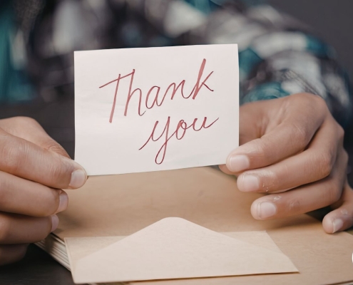 Fundraiser handwriting a personal note to a major donor after receiving a gift