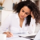 Nonprofit development director looking thoughtfully at a major gift prospect list, frustrated but determined