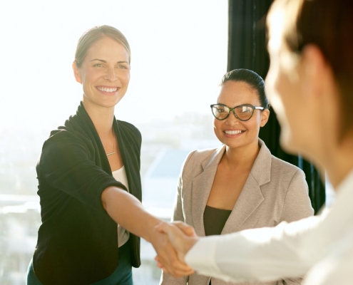 Employer shaking hands with new hire.