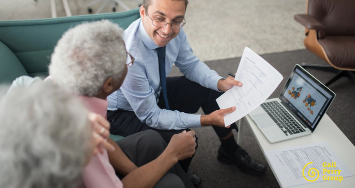 Financial advisor reviewing documents with an older client during a financial planning conversation.