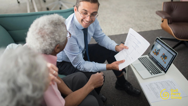 Financial advisor reviewing documents with an older client during a financial planning conversation.