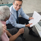 Financial advisor reviewing documents with an older client during a financial planning conversation.